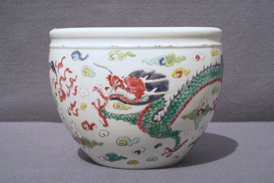 A Chinese blue and white fish bowl and a famille rose 'dragon' jardini&egrave;re, 19th C. and Yongzheng